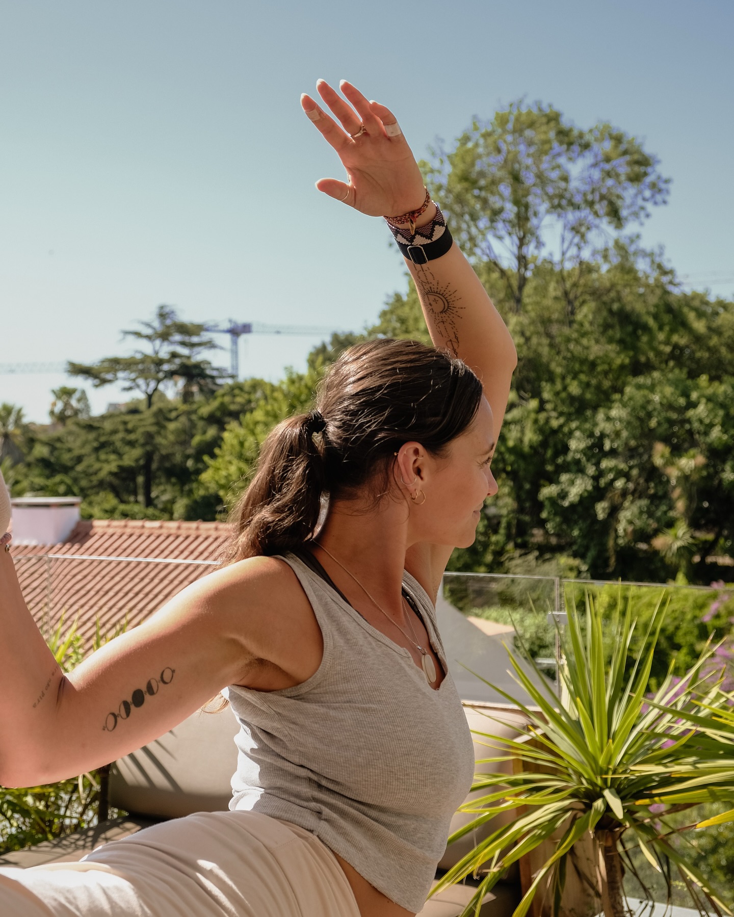 Niamh practicing yoga on a sunlit rooftop terrace